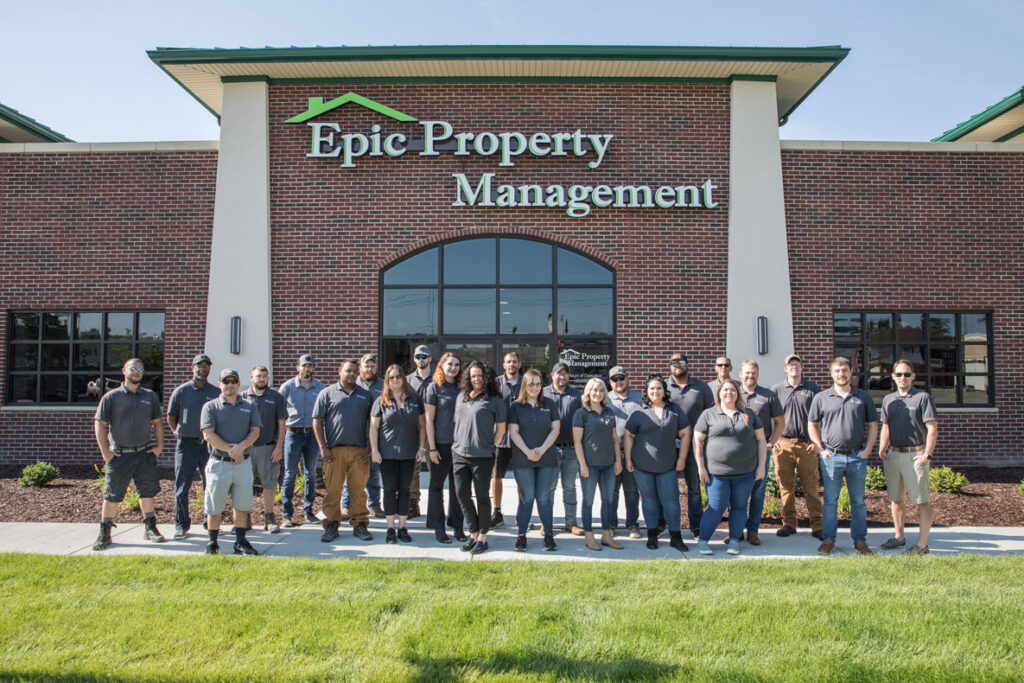 A team of southeast Michigan property management specialists stand in front of their Wyandotte Michigan rental property management offices